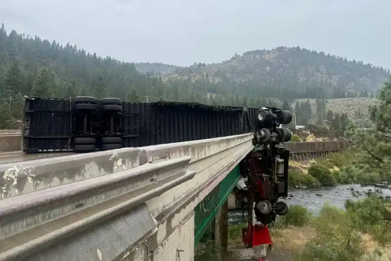 Big rig left dangling over California bridge after crashing through railing