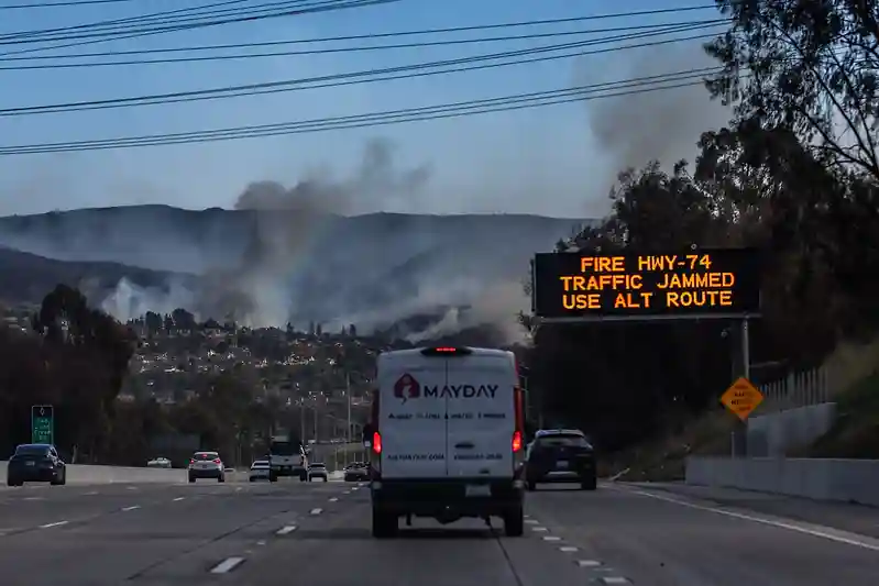 Wildfire forces thousands to evacuate as blaze destroys coastal homes