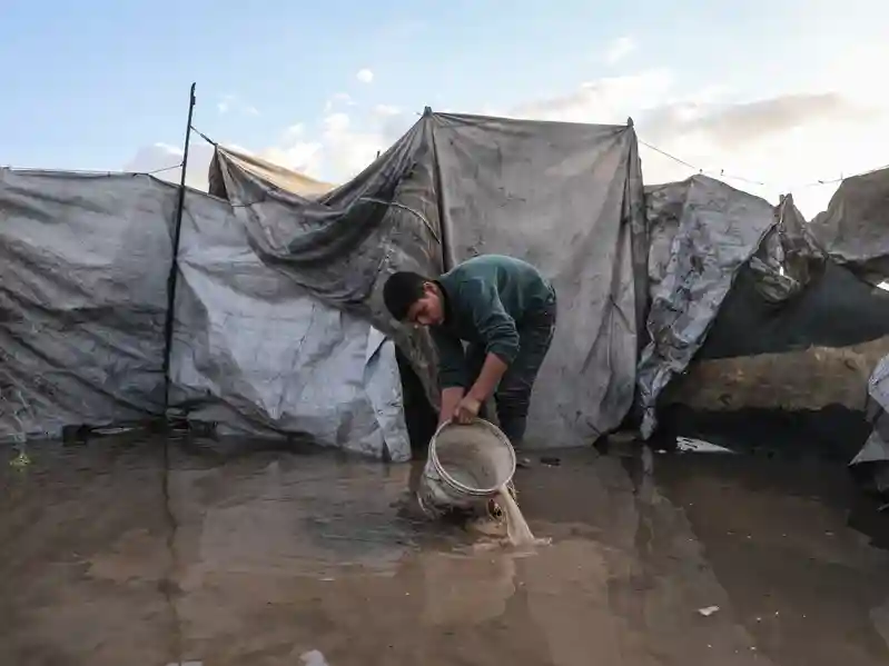 Palestinians suffer flooded tents and debris as cold and rain lash Gaza